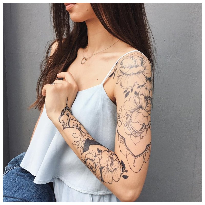 Female full arm tattoo