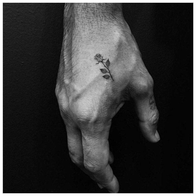 Little rose - tattoo on a man’s hand