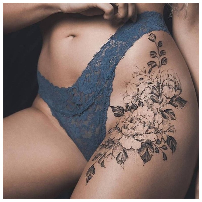 Delicate floral tattoo on the leg