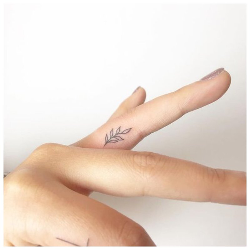 Flower on finger tattoo