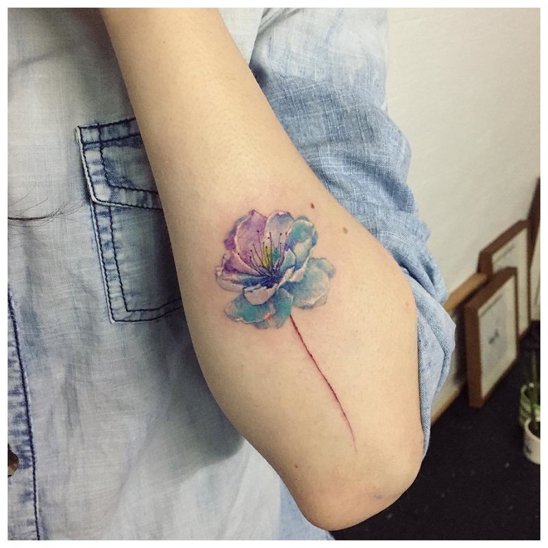 Watercolor flower tattoo on hand