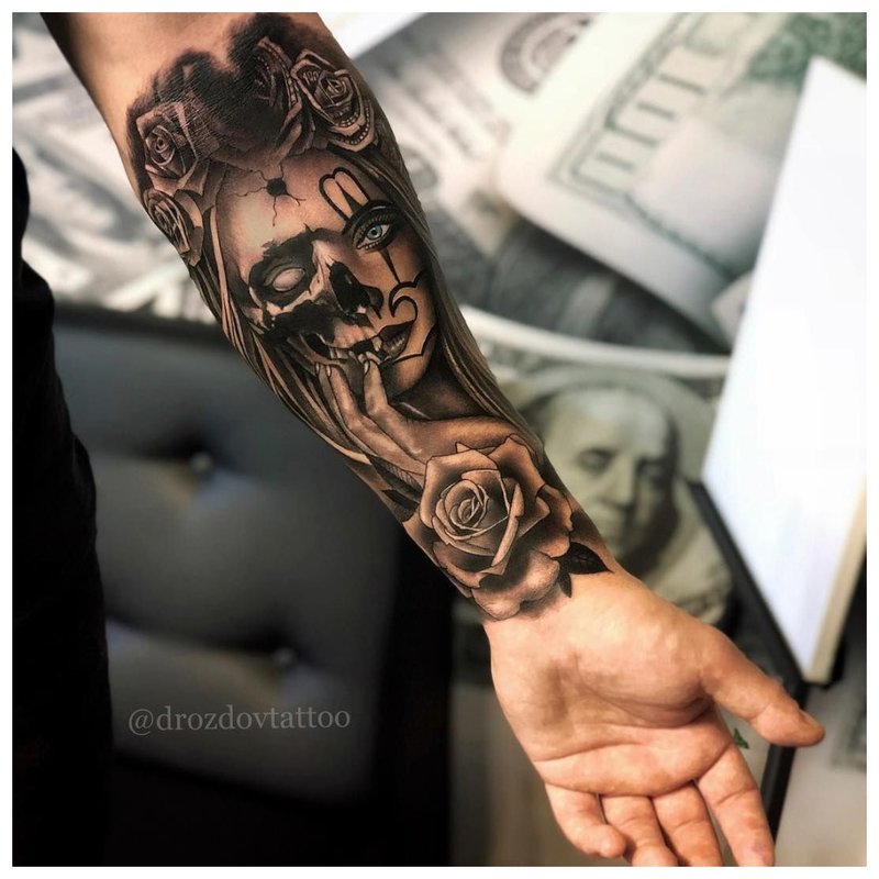 Tattoo of a girl on the forearm of a man