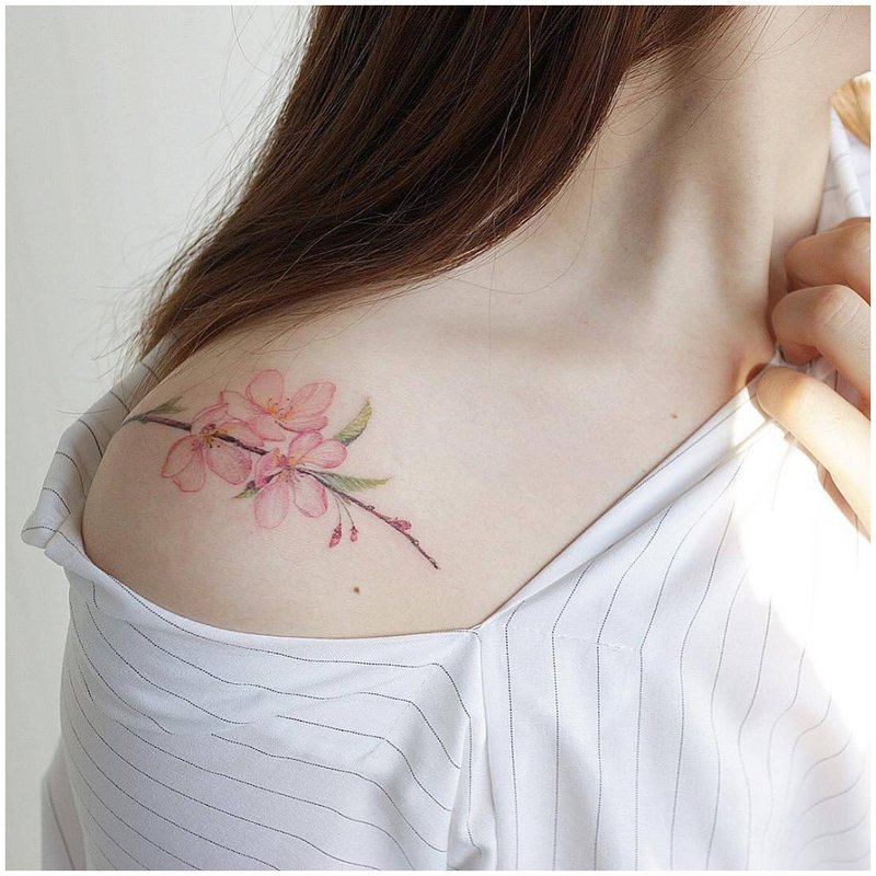 Delicate floral tattoo on the shoulder