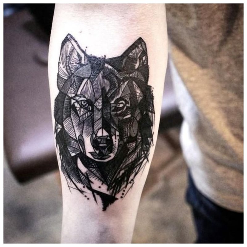 Wolf tattoo on a man’s hand