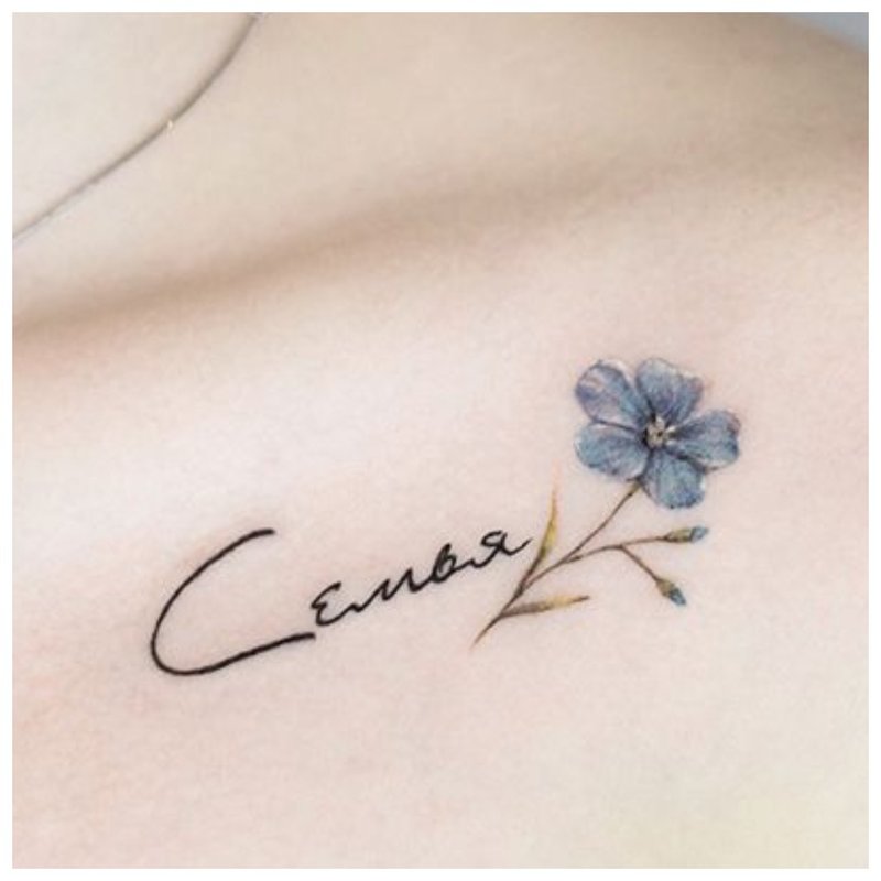 Lettering and flower - clavicle tattoo