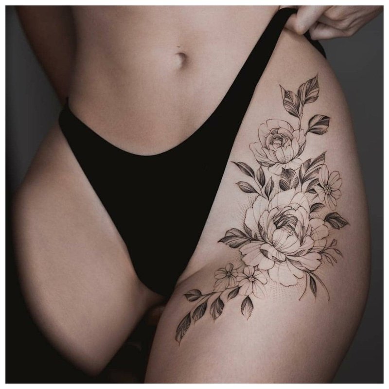 Large floral hip tattoo