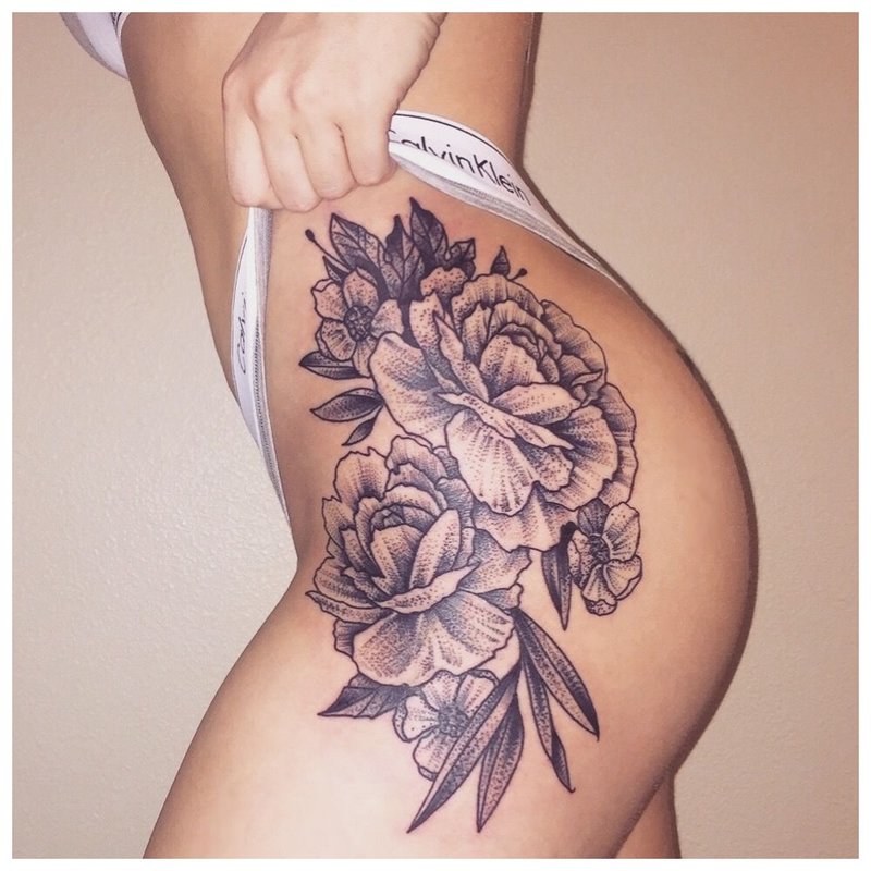 Sexy tattoo on the hip of a girl