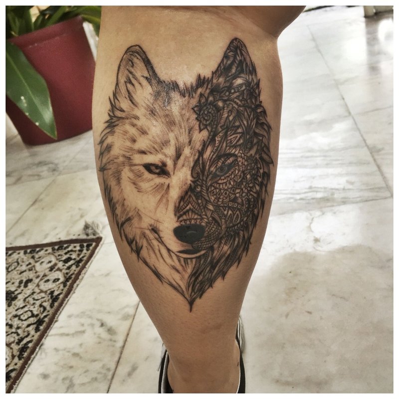 Beautiful wolf tattoo on the calf of a man