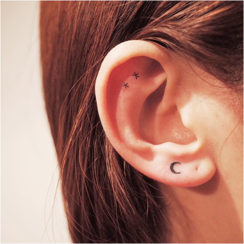 Very minimal tattoo on the ear