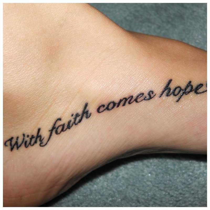 Beautiful tattoo inscription on the leg