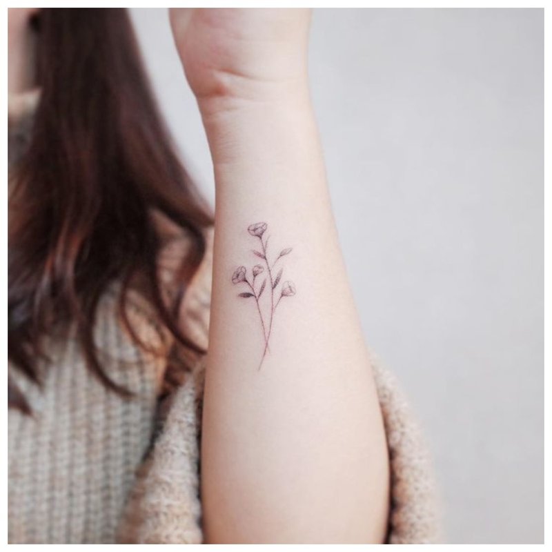 Tender flower tattoo on the arm