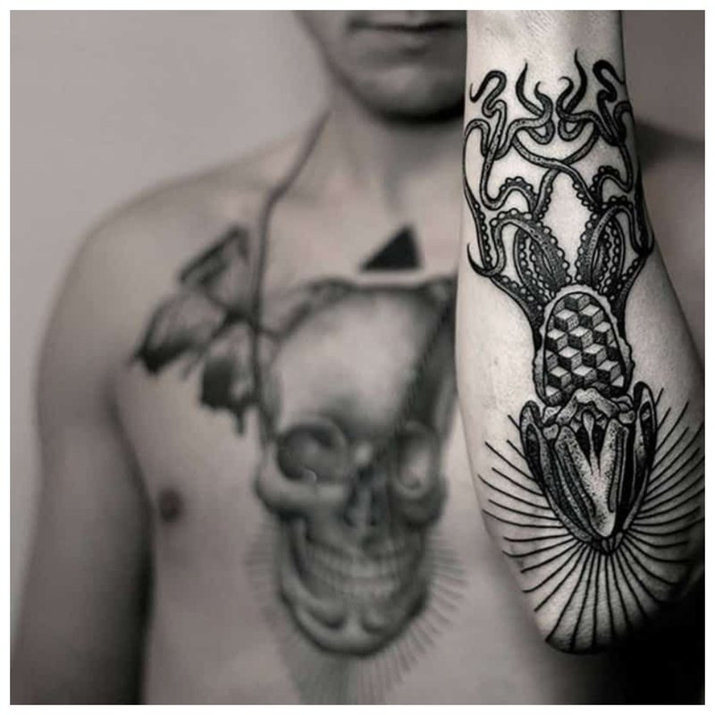 Black tattoo on the forearm and chest