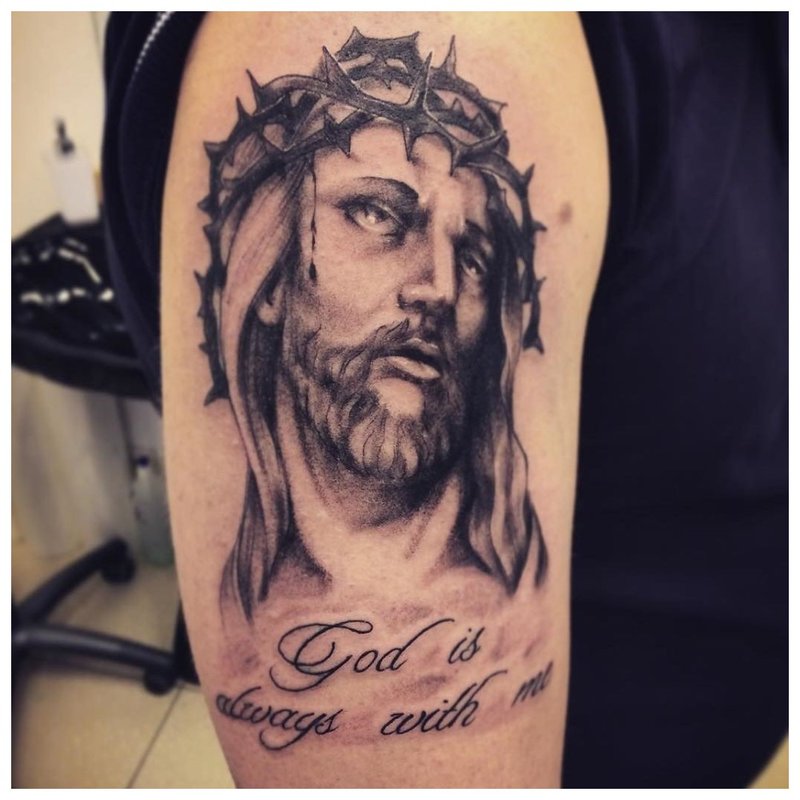 Tattoo inscription with a portrait of Jesus