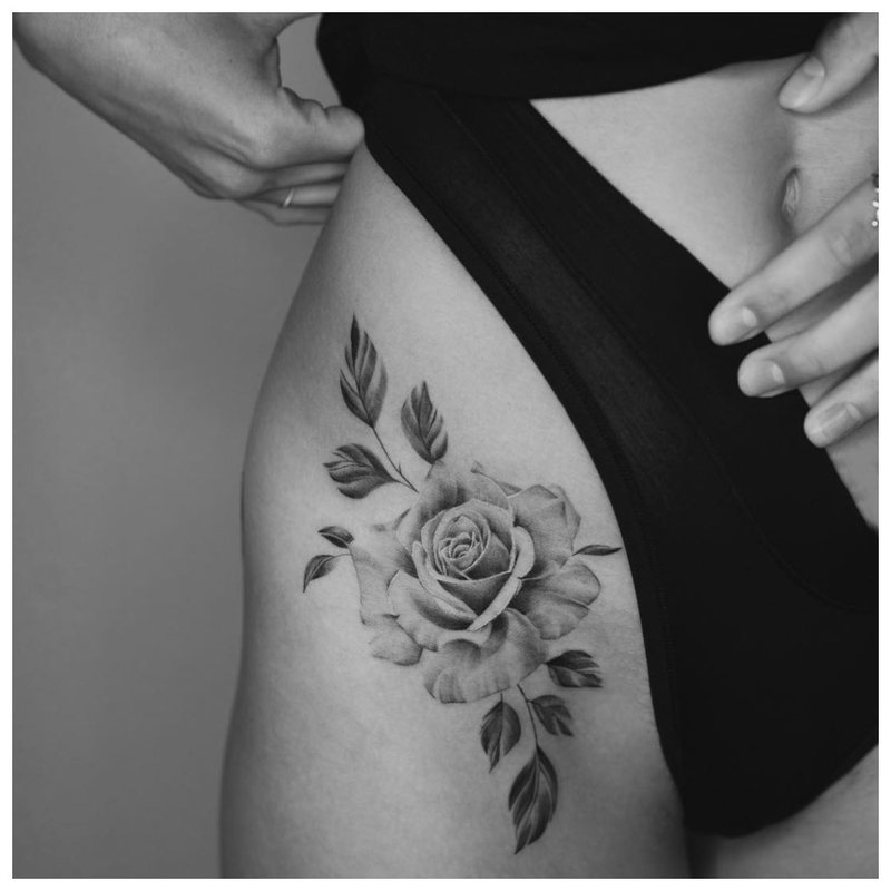 Delicate flower on the hip on the side of the girl