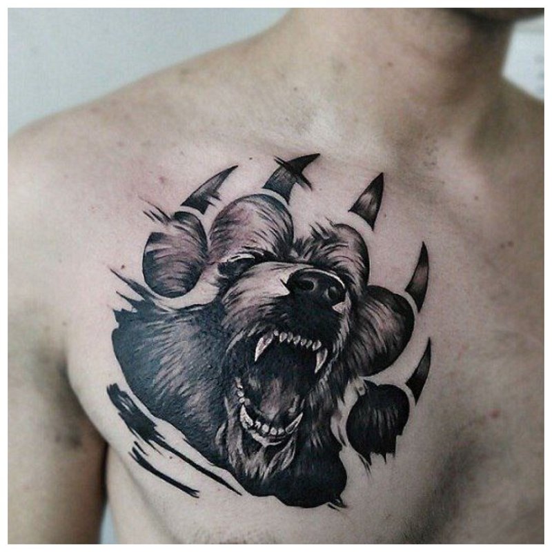 Wolf's paw and mouth - a man’s chest tattoo