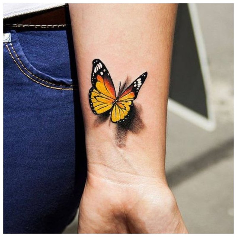 Butterfly - tattoo on the wrist of a girl