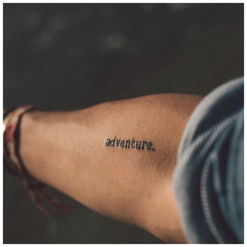 Neat inscription - tattoo on a man’s hand