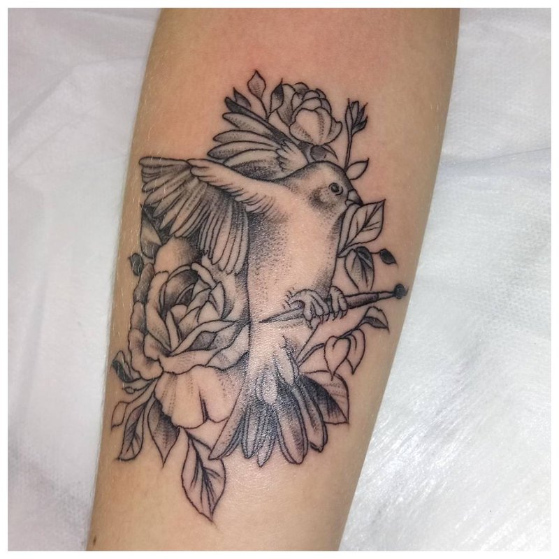 Bird forearm tattoo on men