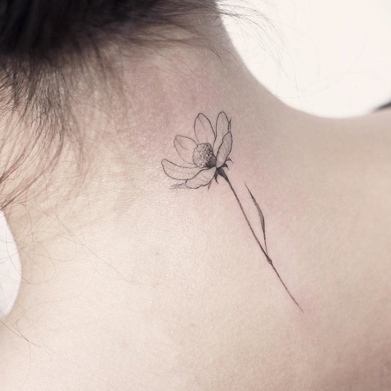 Female tattoo on the back of the neck