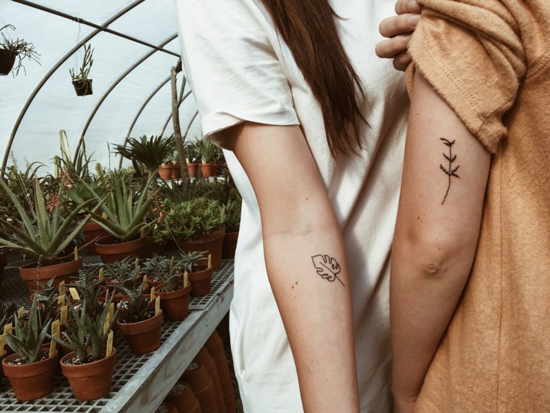 Couple with tattoos on her arm.