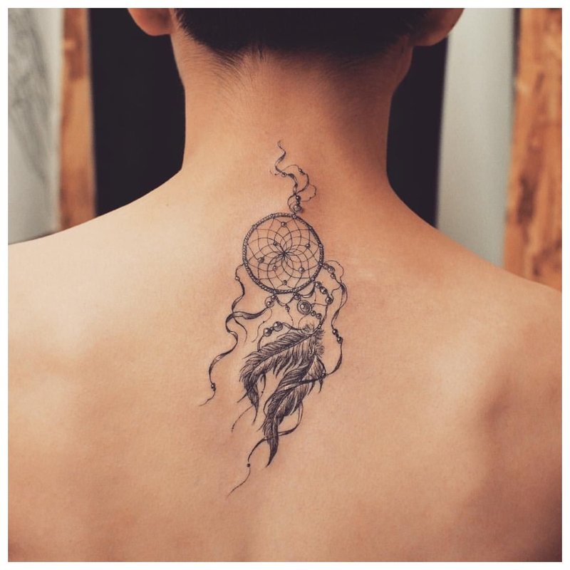 Tattoo amulet on the back of a girl