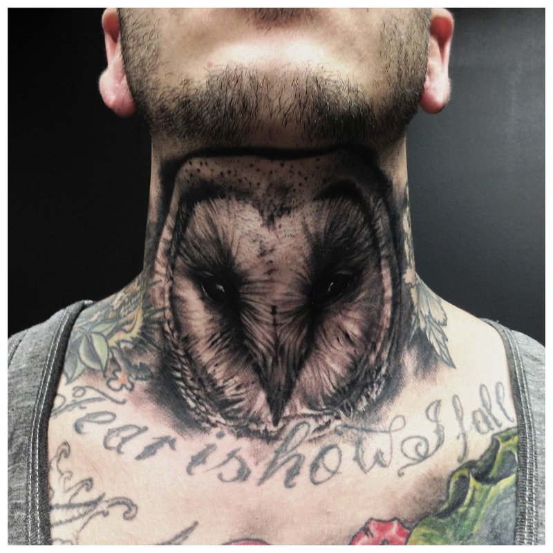 Owl tattoo on the neck in front of a man