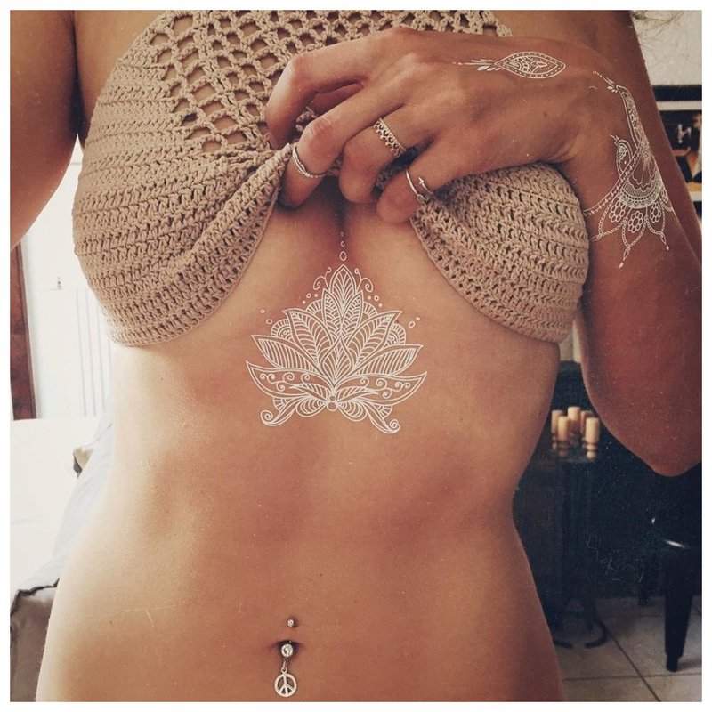 White mehendi tattoo under the chest