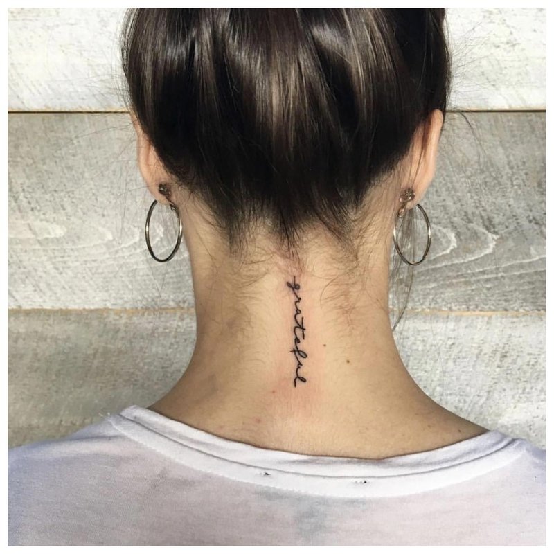 Neat back tattoo on the neck