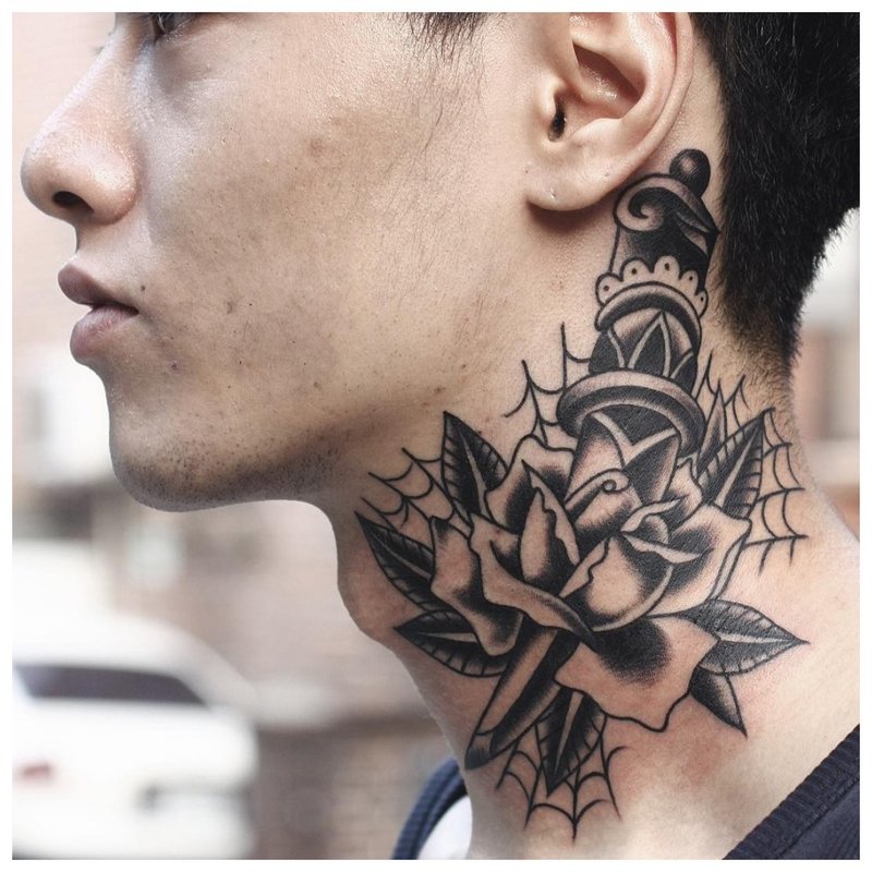 Flower and dagger - tattoo on the neck of a man