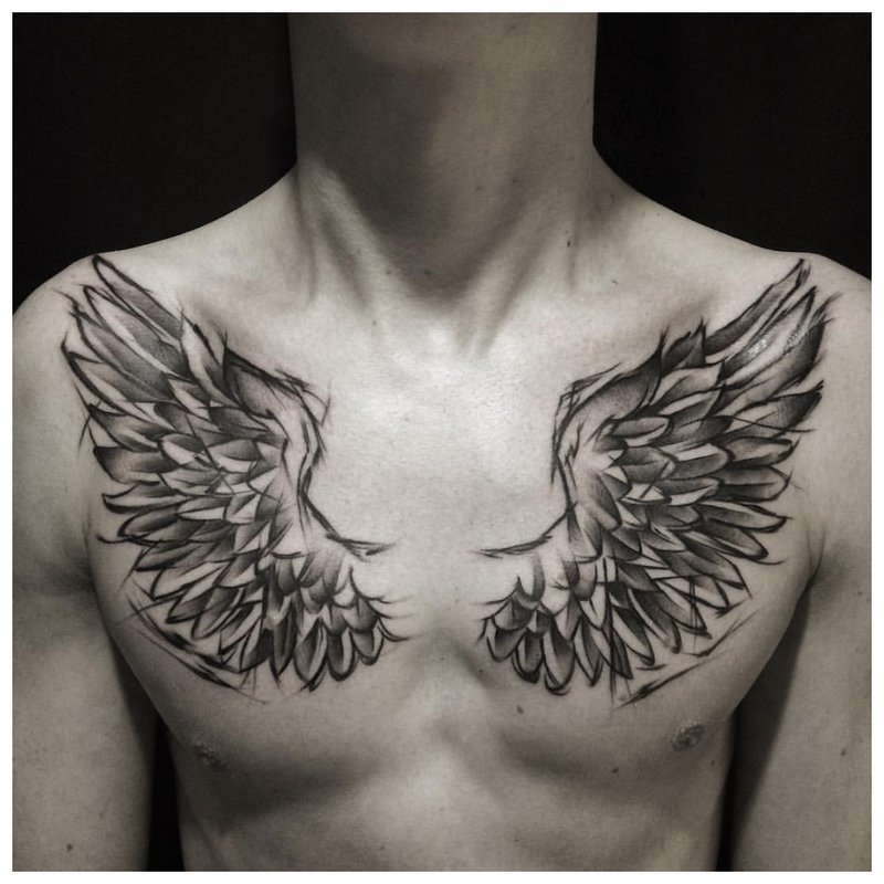 Bird wings - tattoo on man’s chest