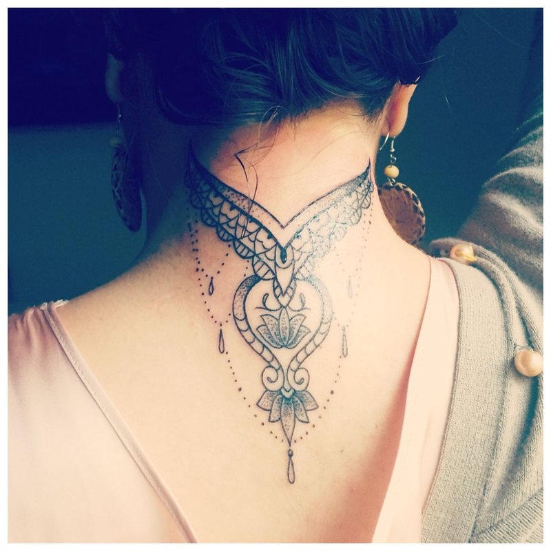 Tattoo on the back and neck of a girl