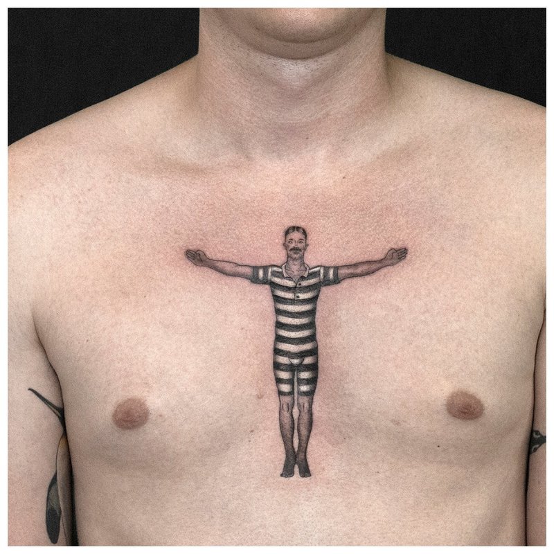 Man tattoo on man’s chest