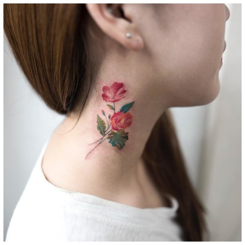 Bright flower on the girl's neck - tattoo