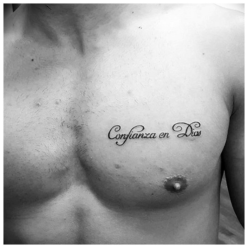 Small tattoo inscription on the chest.