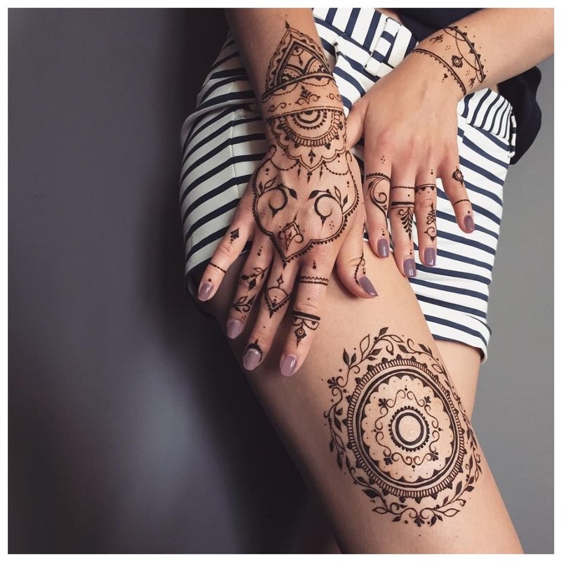 Mehendi tattoo on arms and hip