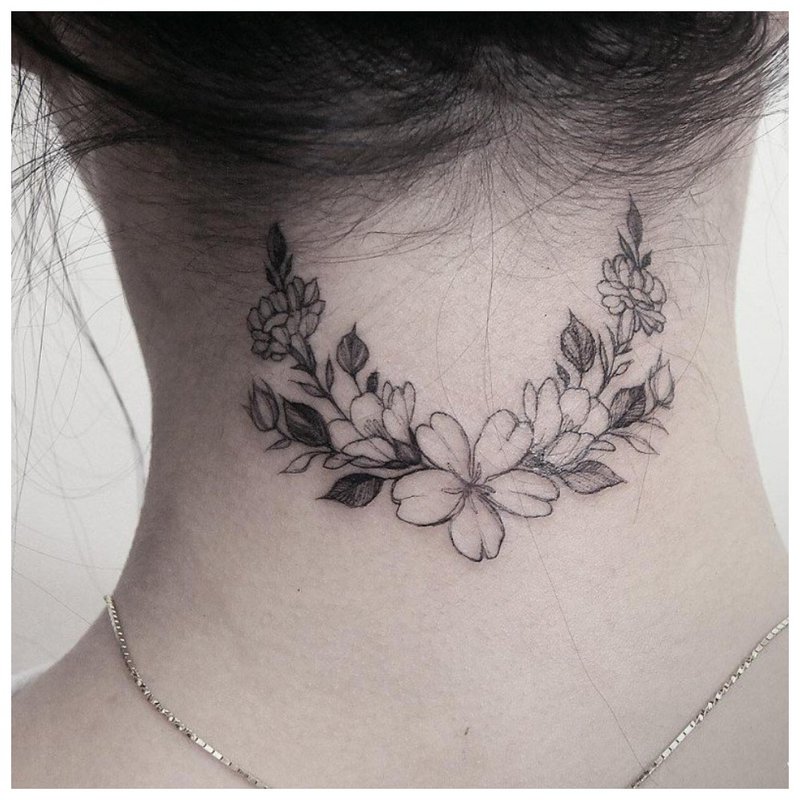 Flower tattoo on the neck at the back of the girl