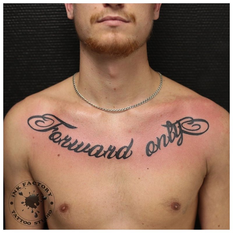 Small tattoo inscription on the chest of a man