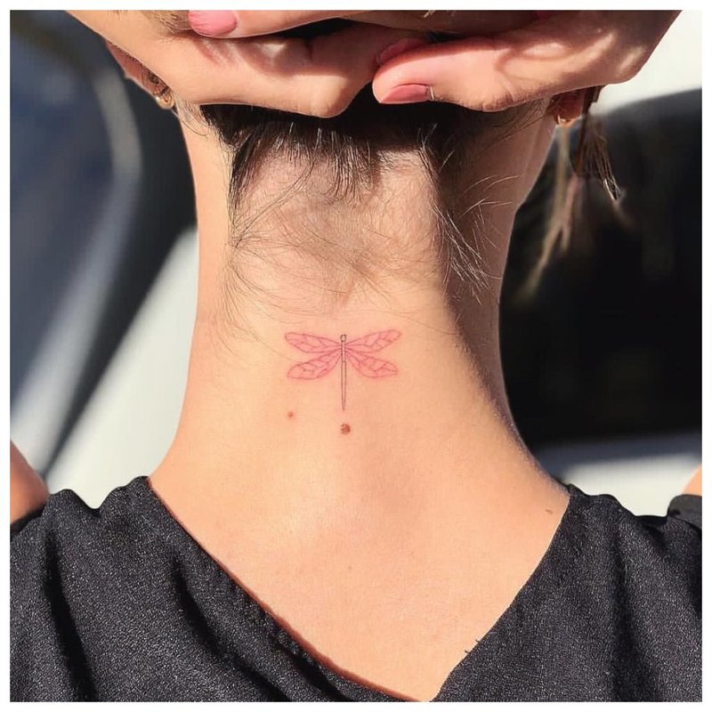 Gentle tattoo on the girl’s neck