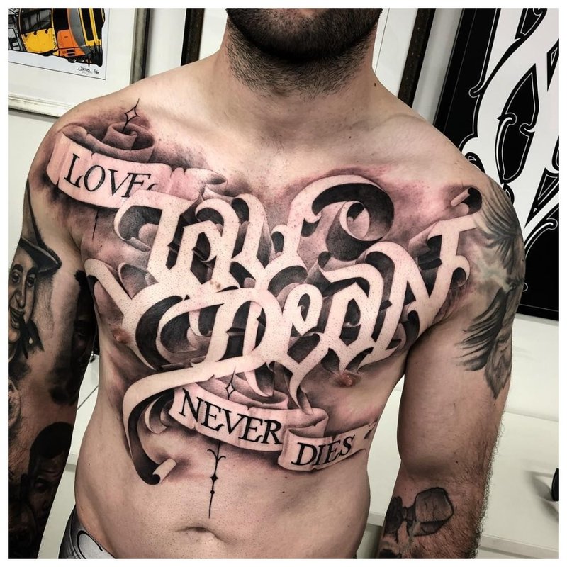 Large inscription - chest tattoo