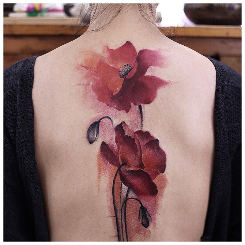 Watercolor tattoo on the back of a poppies