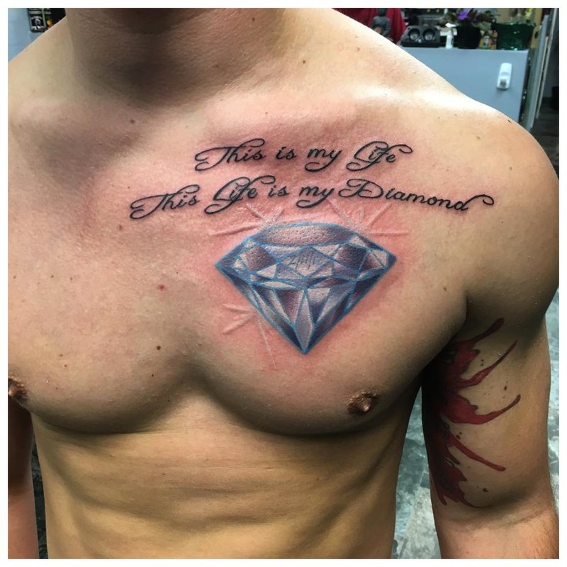 Beautiful tattoo in the form of an inscription on the chest of a man