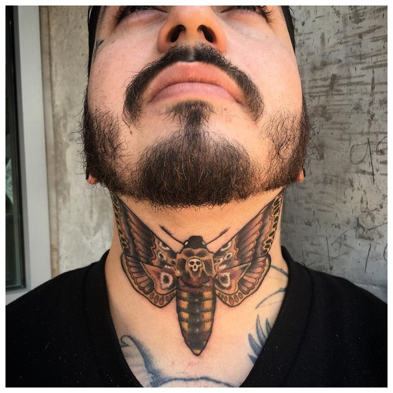 Throat insect tattoo on a man