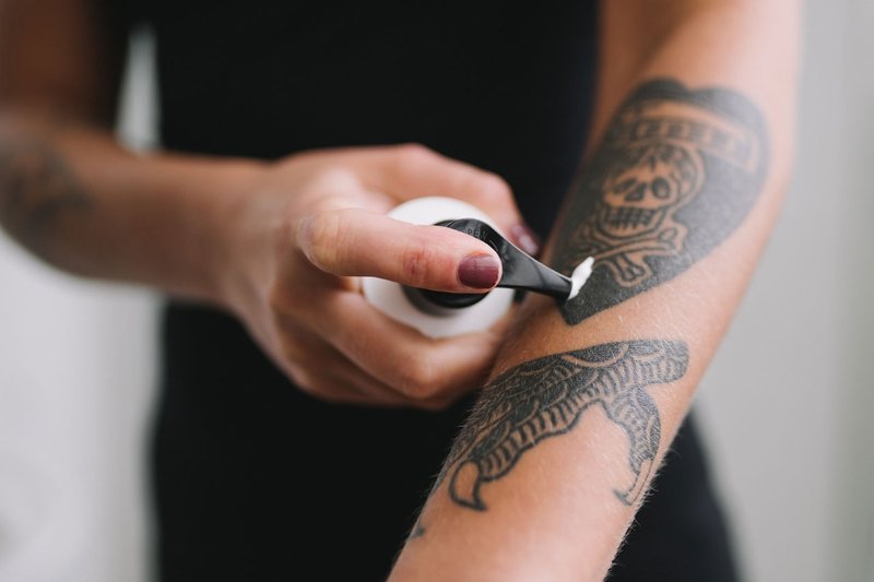 Applying ointment to a tattoo